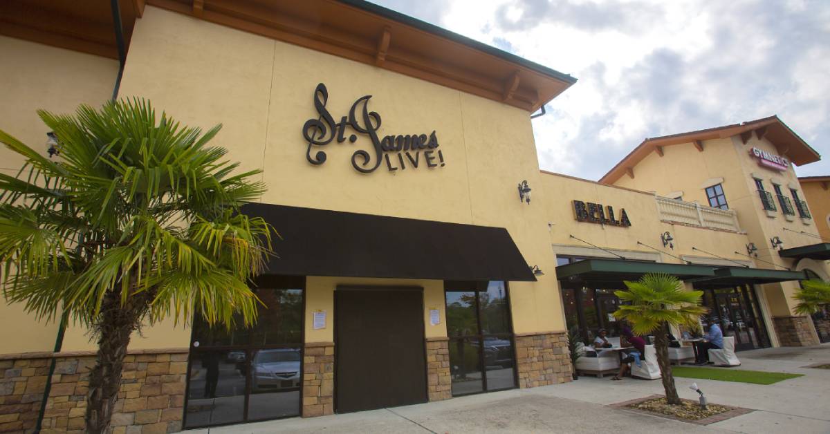 Exterior of a building with _St. James Live!_ sign and palm trees in the foreground
